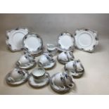 A Tuscan China hand enamelled tea set for 12 decorated with love birds. Includes 2 cake plates and a
