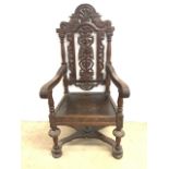 A late 1800â€™s carved throne chair cross stretcher to base.
