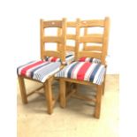 A set of four solid pine dining chairs with matching cushions. H:48cm