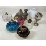 A box of vintage lamp parts including blue, cranberry and ruby glass