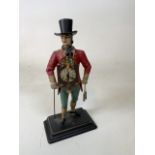 A continental figural pedlar clock styled as a man in top hat with time piece to front and back H: