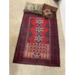 A Caucasian Kazak rug also with an Afghan Baluch and a tapestry cushion W:86cm x H:140cm W:47cm x