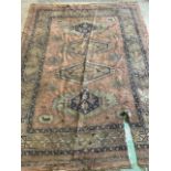 A Large Persian carpet recovered from Morebath manor Tiverton Devon servants quarters. (a.f) W:350cm