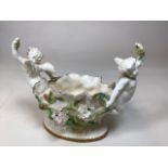 An impressive 19th century Victoria porcelain centrepiece by Moore Bros featuring cherubs with