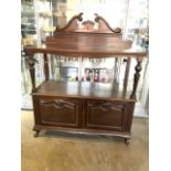 An early 20th century buffet sideboard with fret carved back and tapered supports, with cupboard