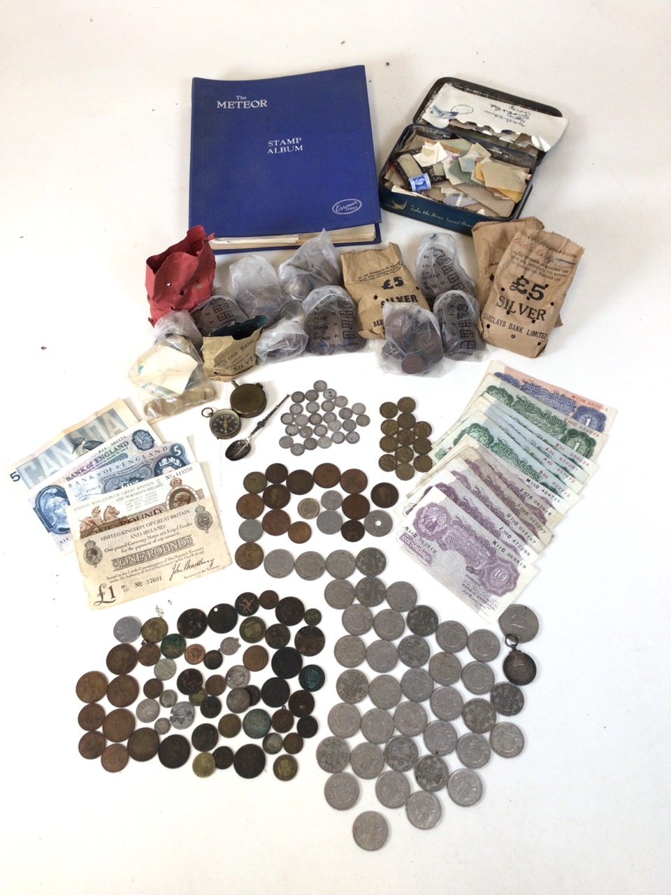 Large assortment of vintage and antique currency, with UK and worldwide coins and notes. Also with a