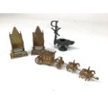 Two brass novelty match strikers by Britains, brass coronation carriage model and replica London