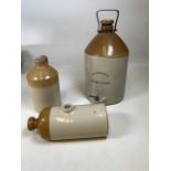 A Whiteways Devon Cyder flagon also with a W Derry & Co Plymouth flagon and a stone hot water bottle