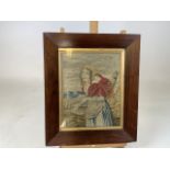 An early nineteen century needle point tapestry of a woman with baby. Verso later inscribed - The