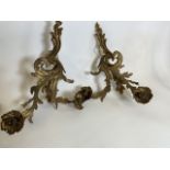 A pair of gilt cast metal two branch wall sconces of elongated leaf form