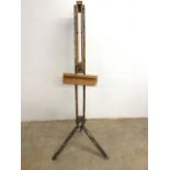 A large adjustable wooden artistâ€™s easel. In used conditions.
