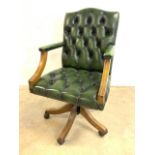 A leather buttoned back swivel office chair with studded finish and adjustable height.