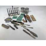 A mixed lot of collectible items including pens, an AA car badge, white metal lidded glass