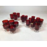 A quantity of ruby red Luminarc Glasses and sundae dishes