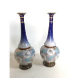 Pair of Lambeth Doulton early 20th century long neck baluster vases. Hand painted decor with gilt