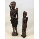 Two African carvings, one of a hunter H: 72cm and one of a woman H: 56cm