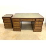 A modern reproduction leather topped pedestal desk with eight drawers also with two drawer filing