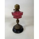 A cranberry glass oil lamp base H:42cm