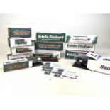 A collection of twelve (12) Eddie Stobart lorries and vehicles, in played with in original boxes.
