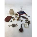 A quantity of interesting items including an ornate pipe, a leather holder, Wade whimsies, brass