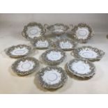 A nineteenth century hand gilded and moulded part dinner set comprising ten 22cm plates, (some