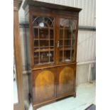 An early 20th glazed bookcase with cupboard below with adjustable shelves to the glazed section,