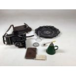 A vintage Voigtlander camera in leather case also with a card case , a vintage can, a compass and
