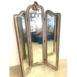 A free standing modern triple mirror or room divider, with shaped bevelled class and fleur de lis