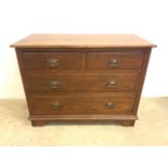 An early 20th century chest of drawers with two short over two long drawers with copper and brass