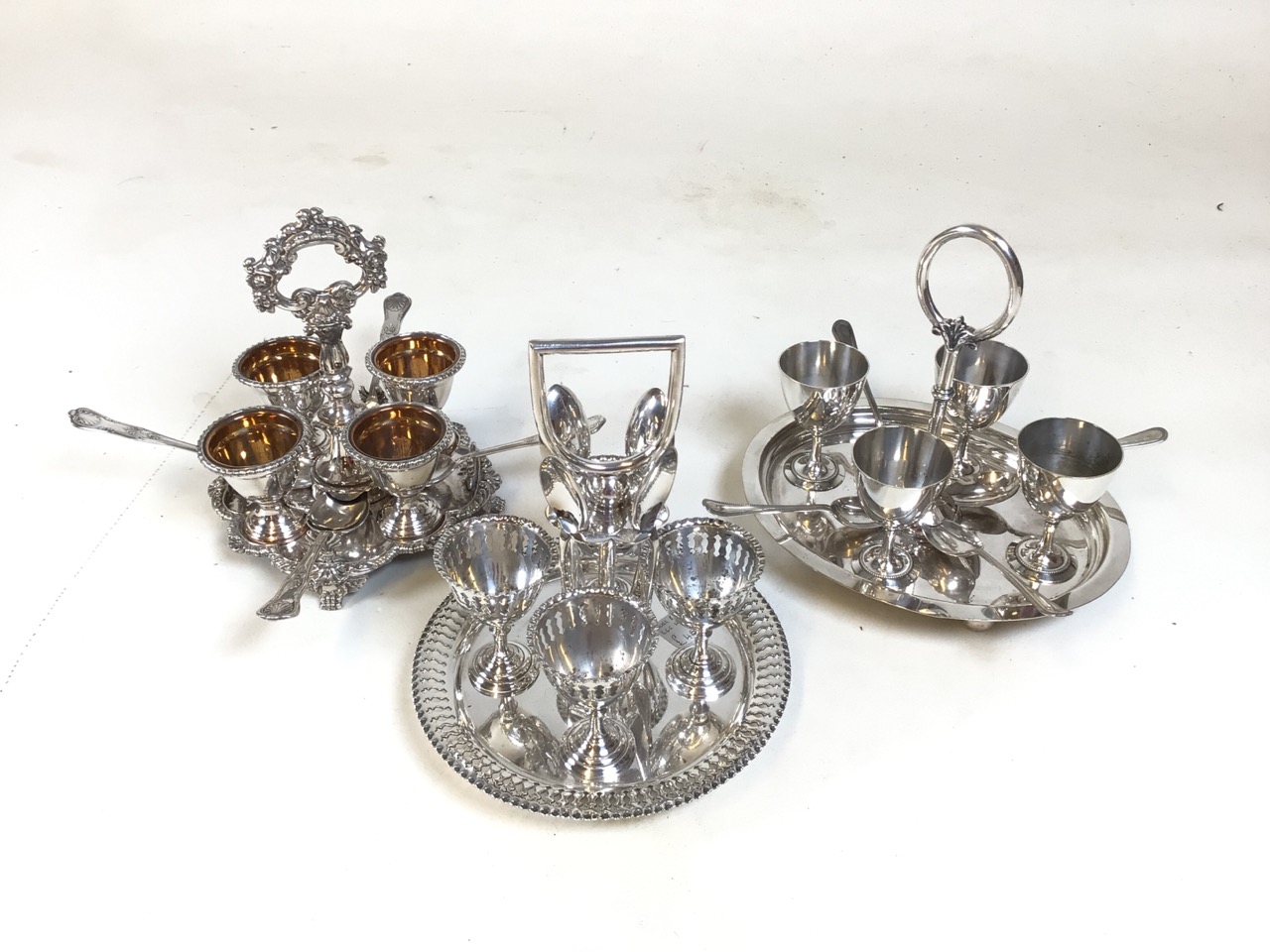 3 silver plate egg cup carousels with spoons. Each set serves 4. All in good condition.