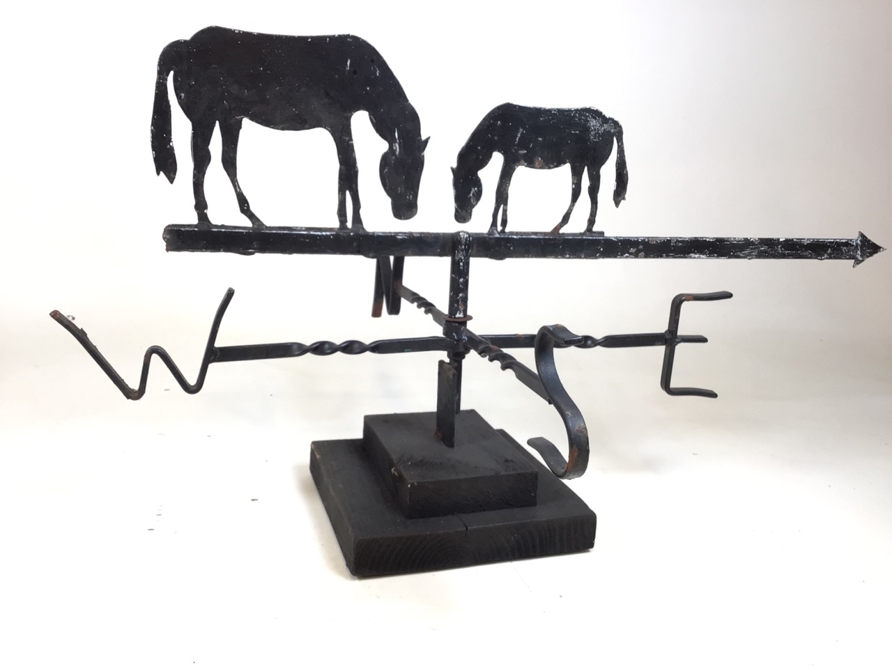 A weather vane with horse decoration on two river wooden plinth. W:78cm x D:58cm x H:44cm