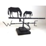 A weather vane with horse decoration on two river wooden plinth. W:78cm x D:58cm x H:44cm