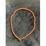 A coral bead necklace.