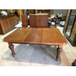 A Victorian mahogany extending dining table with three extra leaves and a winder. W:170cm x D: