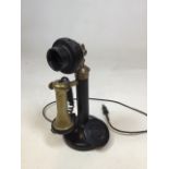 A candle stick telephone with metal stand and Bakelite earpiece.Untested! H:31cm