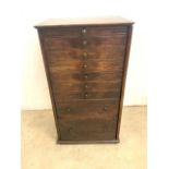 A late 19th early 20th century bank of nine drawers with metal handles, with side locking panel,