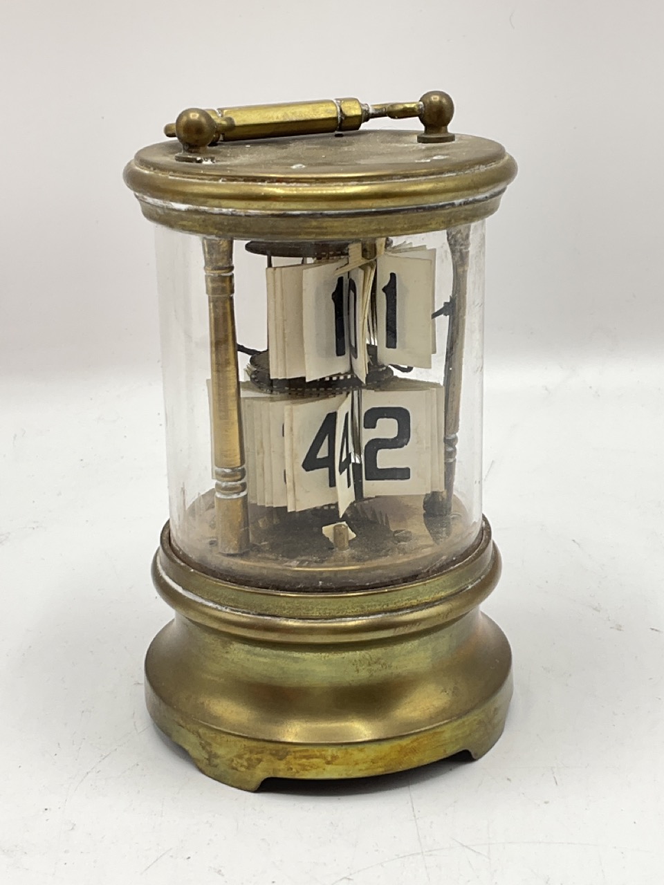 Late 19th century ticket or flip-dial clock. AF condition, the case and mechanism not secured. Brass