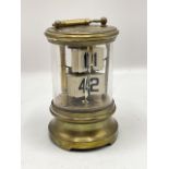 Late 19th century ticket or flip-dial clock. AF condition, the case and mechanism not secured. Brass