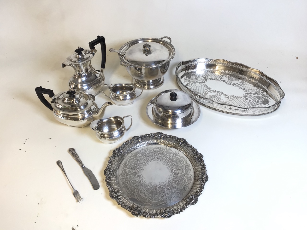 Assortment of silver plate items to include a tureen, two serving trays and a tea-coffee set. Handle