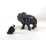 Two elephant figures, one desk size and one miniature. Larger elephant is cast metal. Fair to good