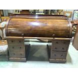 A large Victorian mahogany roll top pedestal desk, each pedestal with three drawers, roll top to