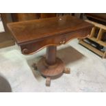 A mahogany tea table on large octagonal fluted base on circular plinth with metal castors. With fold