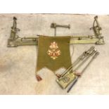 A brass fire fender also with good quality fire irons and an armorial needle work fire screen.