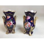 A pair of Rocco Style vases - hand painted flowers on blue ground probably Daniel - marked 202 to