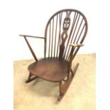 An Ercol beech rocking chair with Ercol sticker. W:74cm x D:79cm x H:94cm