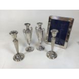 One pair of hallmarked silver candle stands, with weighted bases. With a pair of posy vases, with