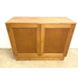 An mid century oak two door cupboard with inter nal shelf and working key. W:107cm x D:40cm x H: