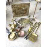 A collection of brass and copper wares, to include heady brass fire irons etc