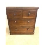 A small mahogany veneered chest of drawers with two short over two long drawers. W:90cm x D:50cm x