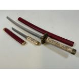 An Eastern Sword and dagger with faux leather scabbards with resin handles. Sword 70cm approx.